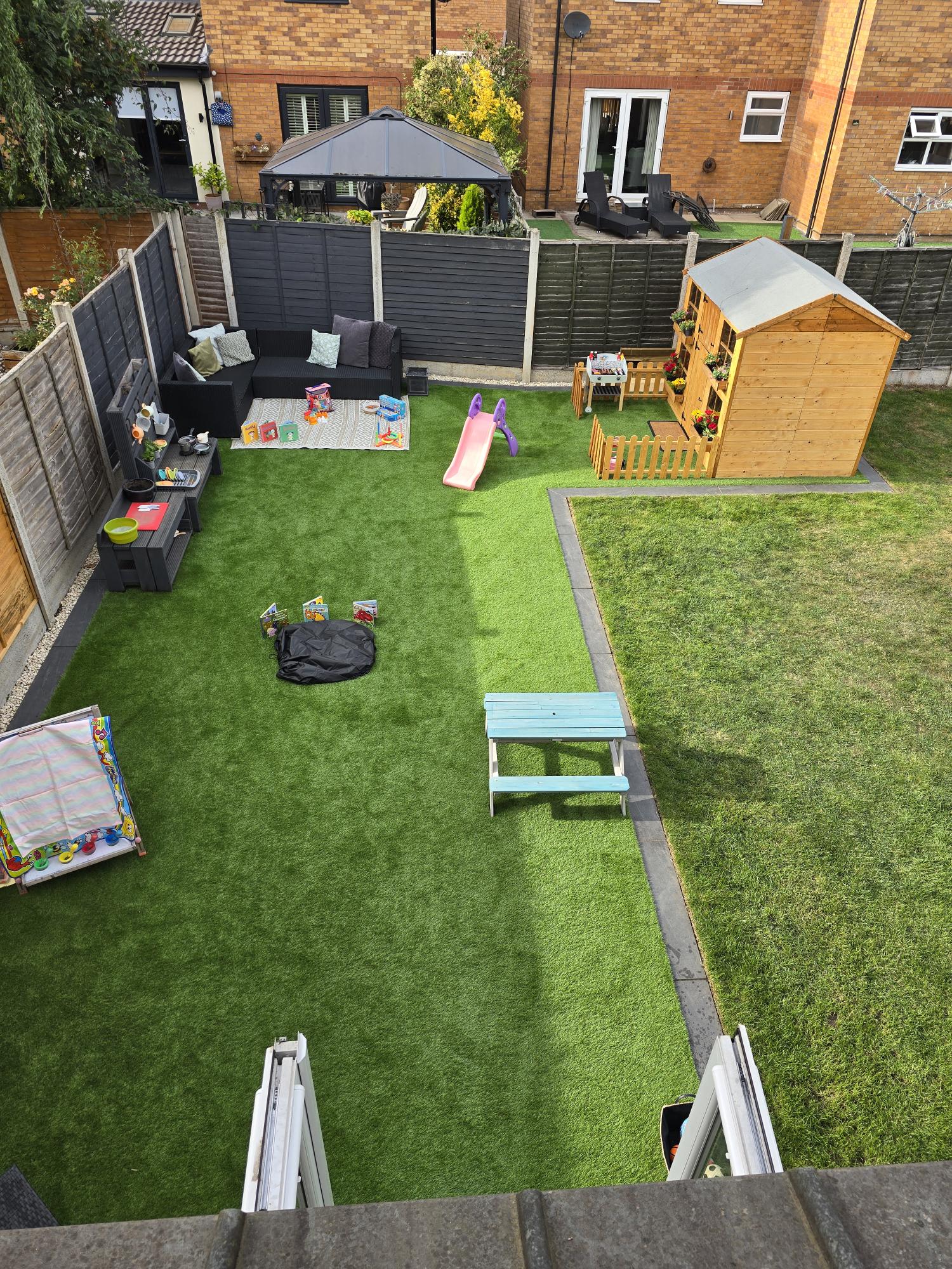 Our secure garden in Kirk Sandall with slide, mud kitchen, playhouse and outdoor play areas
